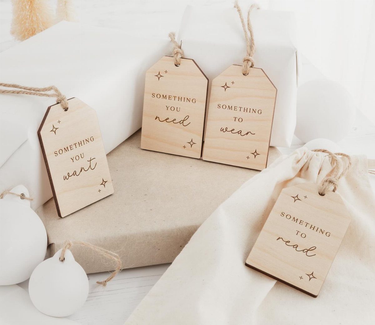 21 Small Wood Projects for Christmas You Can Make 14 Wooden gift tags with engraved text attached to wrapped holiday presents and bags.
