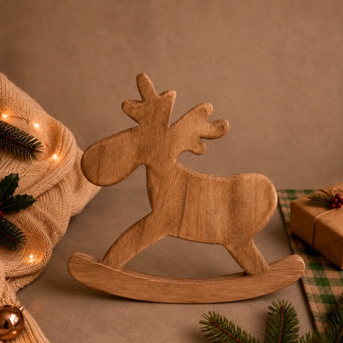 21 Small Wood Projects for Christmas You Can Make 16 Wooden reindeer decoration on a rocking base surrounded by cozy Christmas holiday decor.