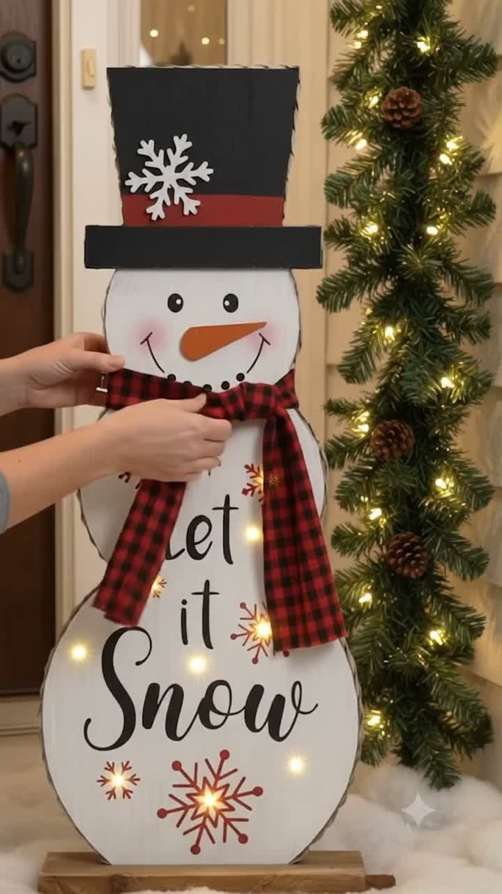 21 Small Wood Projects for Christmas You Can Make 7 Wooden snowman cutout with a black top hat and red plaid scarf.