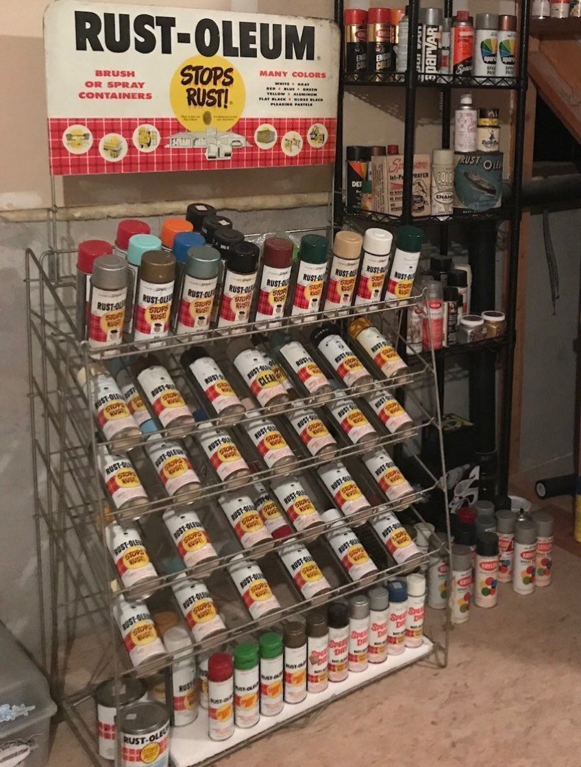 12 Small Workshop Storage Ideas for Tight Spaces 11 Wire storage rack filled with organized aerosol spray paint cans in a workshop.