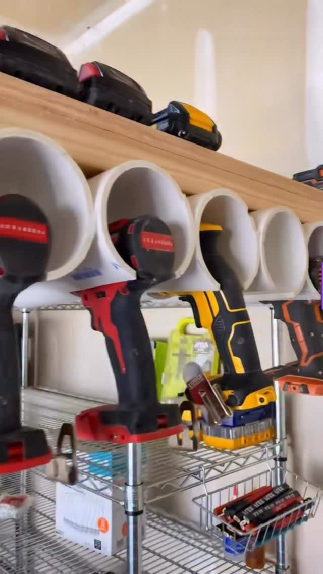 12 Small Workshop Storage Ideas for Tight Spaces 10 Power drills stored in white PVC pipe holders under a wooden shelf.