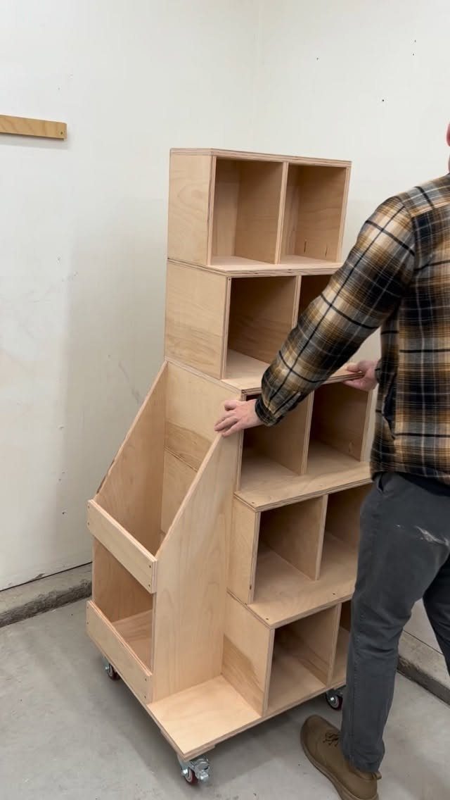 12 Small Workshop Storage Ideas for Tight Spaces 4 Plywood scrap wood storage shelving unit on wheels in a workshop with a man.