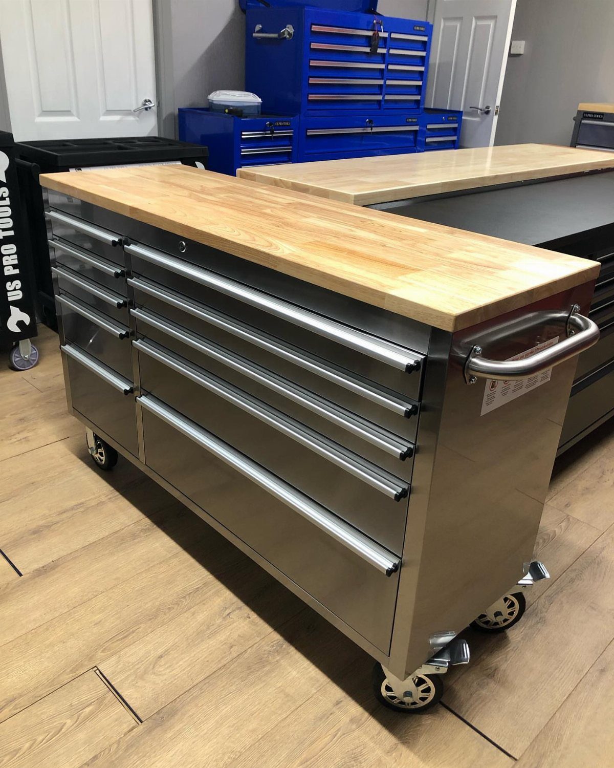 12 Small Workshop Storage Ideas for Tight Spaces 7 Silver rolling tool chest with wooden top and drawers in a workshop.