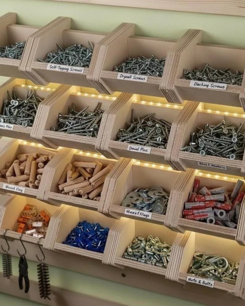 12 Small Workshop Storage Ideas for Tight Spaces 2 Wooden wall-mounted bins organizing various screws, bolts, and dowels in a workshop.