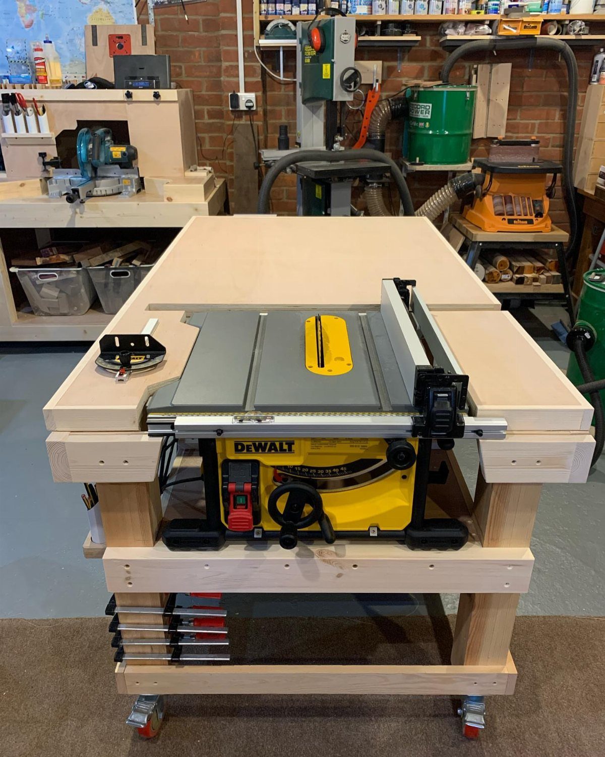 Space Saving Workbench Ideas: 4 Designs for Small Shops 4 Wooden workbench with integrated table saw on caster wheels in a workshop.