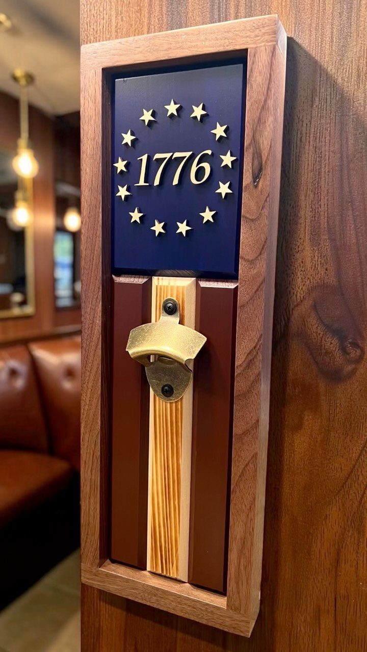 24 Summer Wood Projects for Beginners and Weekend Builders 15 Wall-mounted wooden bottle opener with patriotic stars, 1776 text, and red white blue stripes.