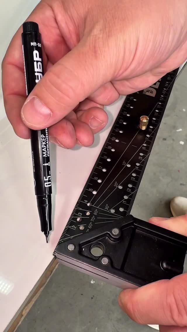 Combination square and marker being used to mark a line on white board