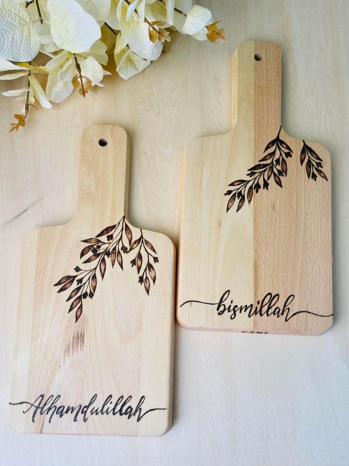 12 Wood Burn Designs for Beginners: Strokes and Patterns 8 Wooden cutting boards with burned botanical leaves and elegant cursive calligraphy text.