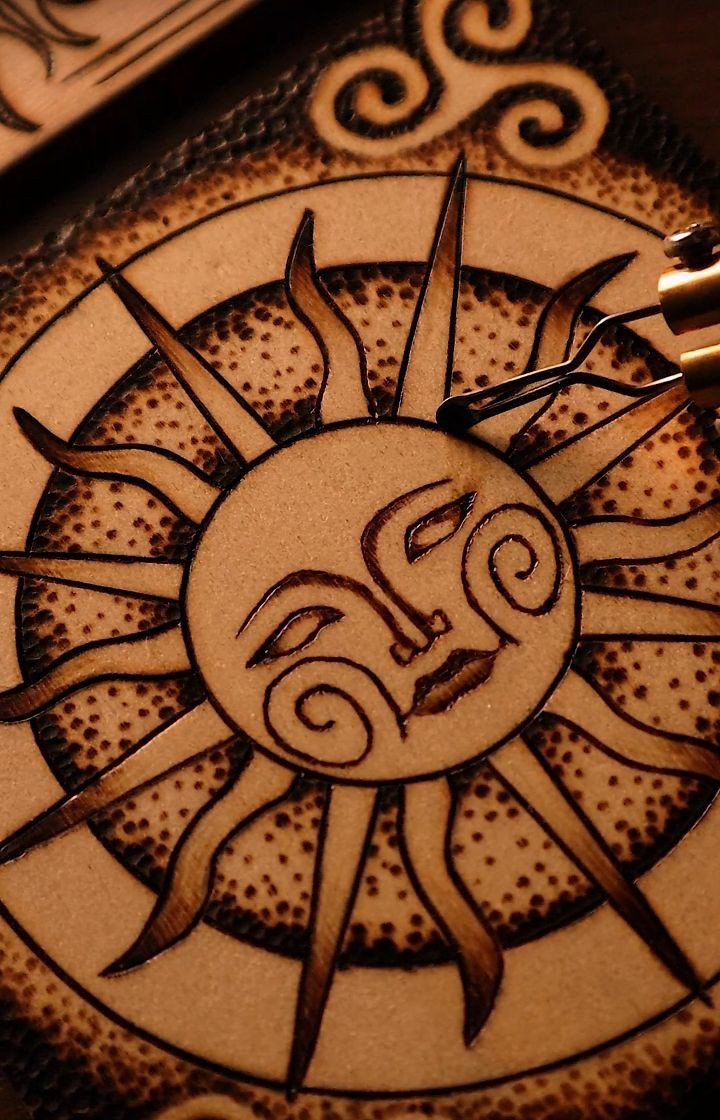 12 Wood Burn Designs for Beginners: Strokes and Patterns 4 Wood-burned sun face with radiating rays and stippled dot shading on light wood