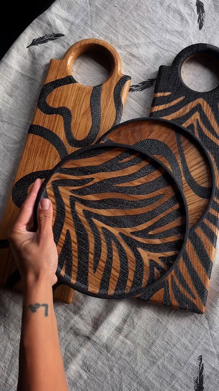 12 Wood Burn Designs for Beginners: Strokes and Patterns 5 Wooden platters and boards with burnt-in black organic swirls and wavy patterns.