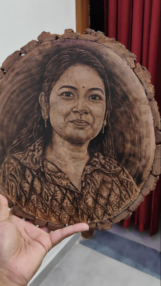 Wood Burning Art: 8 Ideas for Spoons, Coasters and More 6 Detailed wood-burned portrait of a woman on a natural circular wood slice.