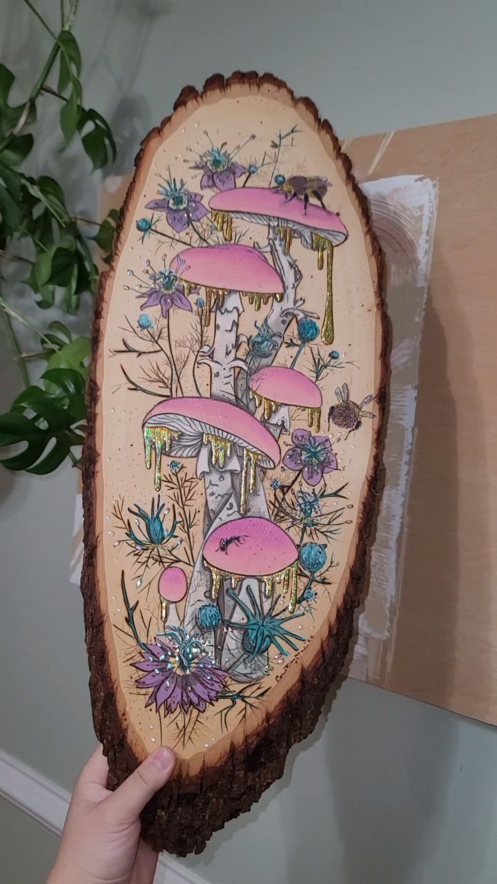 Wood Burning Art: 8 Ideas for Spoons, Coasters and More 2 Wood slice art featuring pink mushrooms and purple flowers created with wood burning and paint.