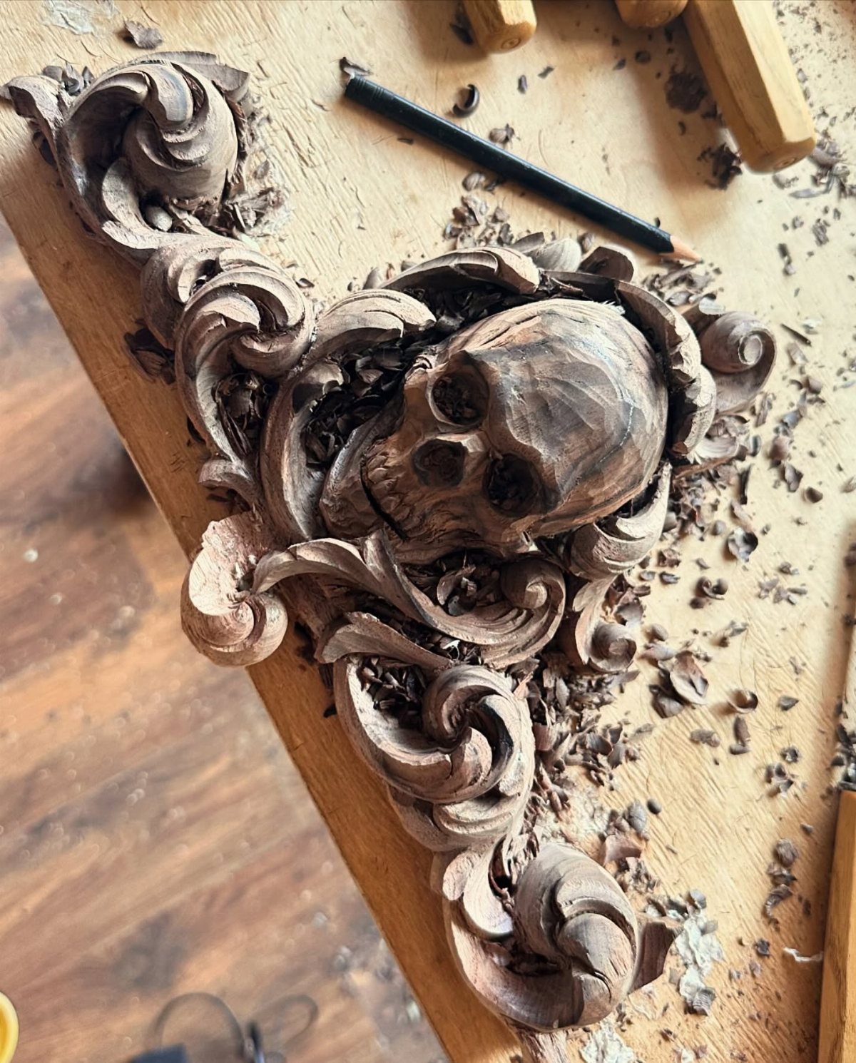 Wood Carved Ornaments: 7 Ideas for Holiday and Home 6 Wood carved skull with ornate scrolls on a workbench with wood shavings
