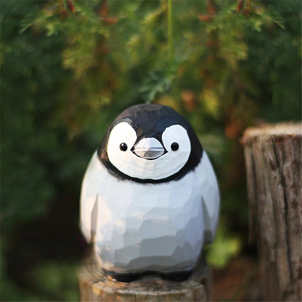 Wood Carving Animals: 14 Ideas to Try With a Knife 7 Carved wooden penguin with black and white paint sitting on a tree stump.