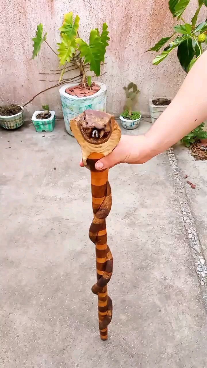 6 Wood Carving Snake Ideas for Every Skill Level 2 Wooden walking cane carved as a striped snake with a detailed head handle.