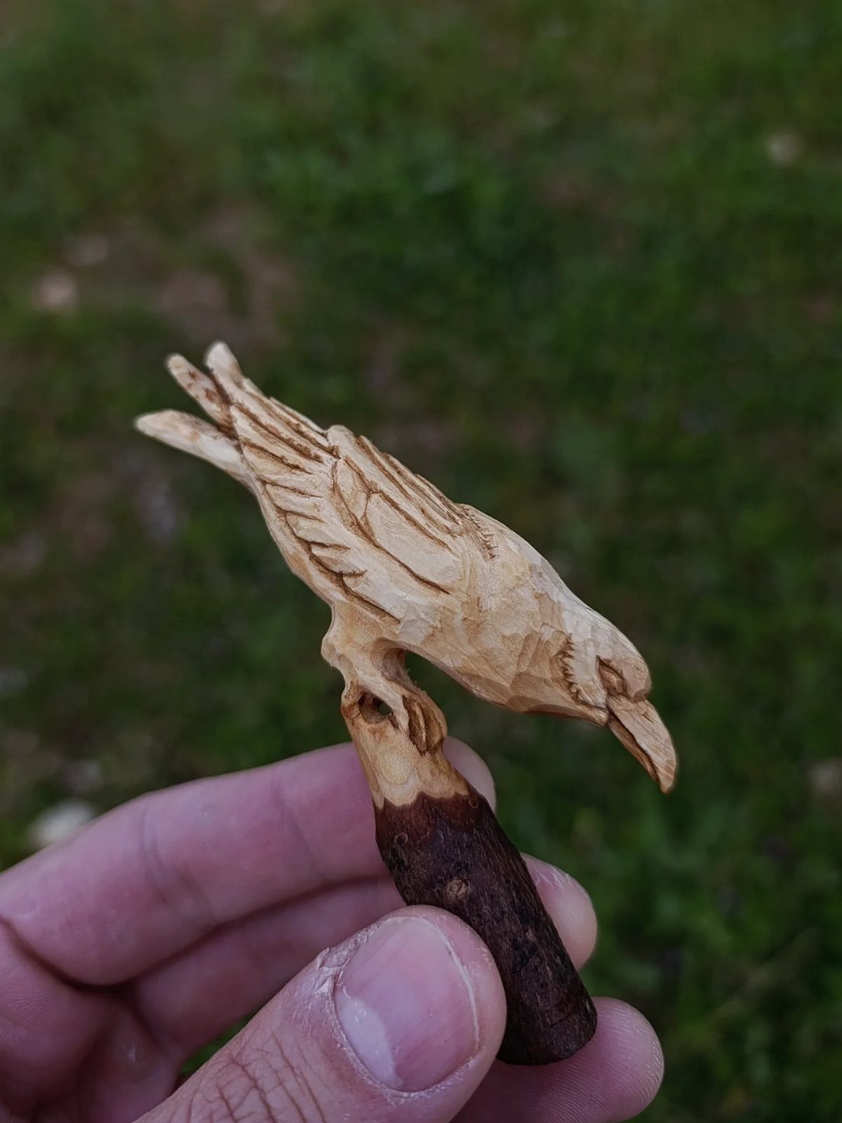 5 Wood Carving Tutorials for Spoons, Waves and Fairy Houses 2 Hand-carved wooden bird perched on a small branch held by a person's hand.