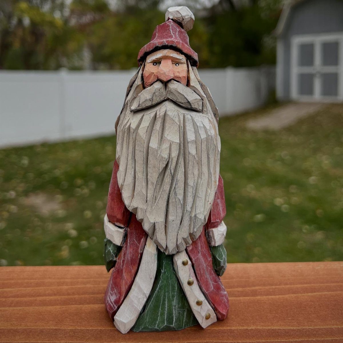 5 Wood Carving Tutorials for Spoons, Waves and Fairy Houses 4 Hand-carved wooden gnome figure with a long white beard and red holiday clothing.