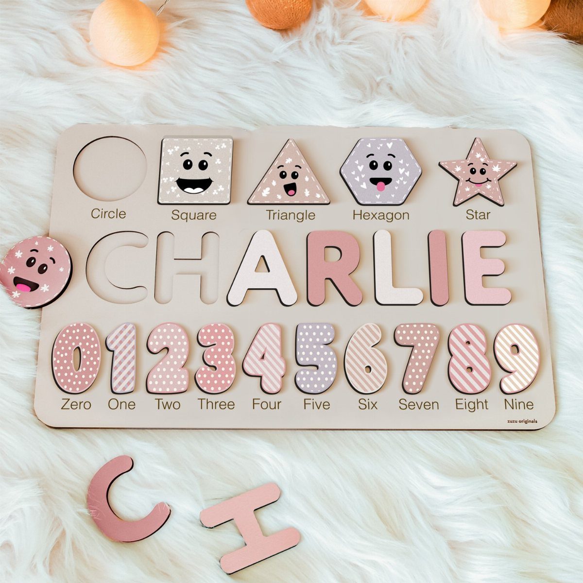 14 Wood Ideas to Sell: Easy Projects for Craft Fairs 11 Wooden name puzzle for Charlie with shapes and numbers on white fur.