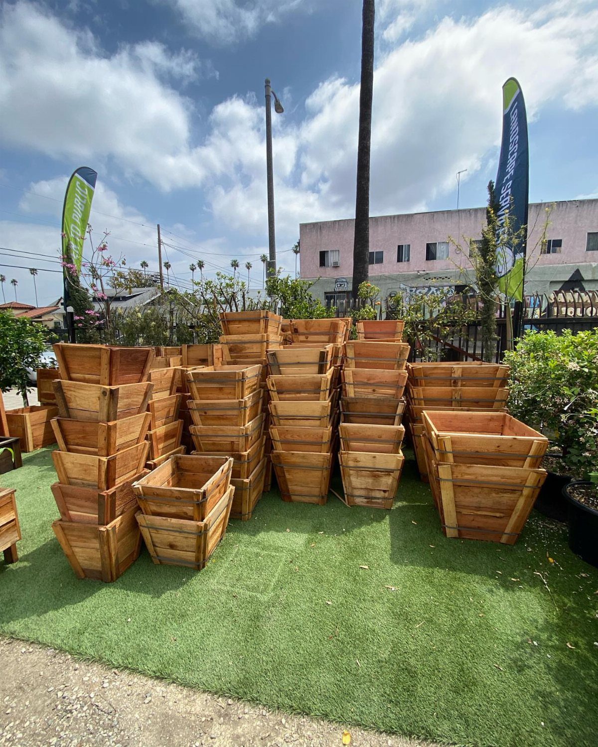 14 Wood Ideas to Sell: Easy Projects for Craft Fairs 4 Wooden planters of various sizes stacked on green artificial grass outdoors.