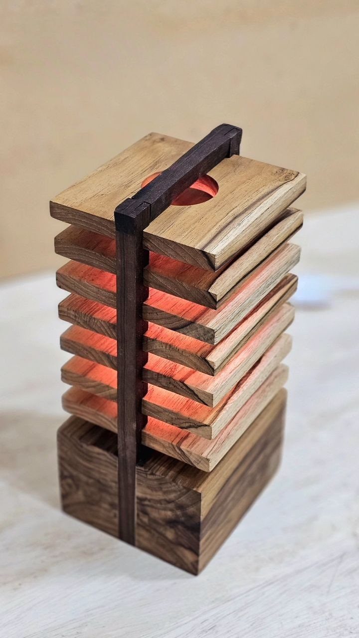 Wood Lamp Design: 14 Table, Floor and Pendant Ideas 8 Modern wooden table lamp with stacked light wood slats and a dark walnut base.