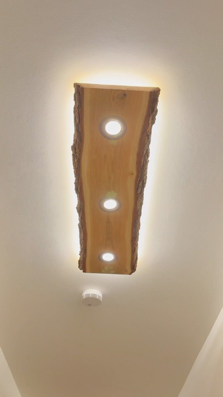 Wood Lamp Design: 14 Table, Floor and Pendant Ideas 13 Wooden ceiling lamp with live edges and three recessed circular lights.