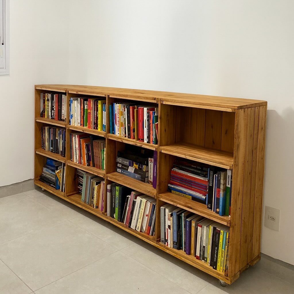 17 Wood Pallet Projects for Furniture, Decor, and Garden 4 Wooden pallet bookshelf filled with colorful books against a white wall