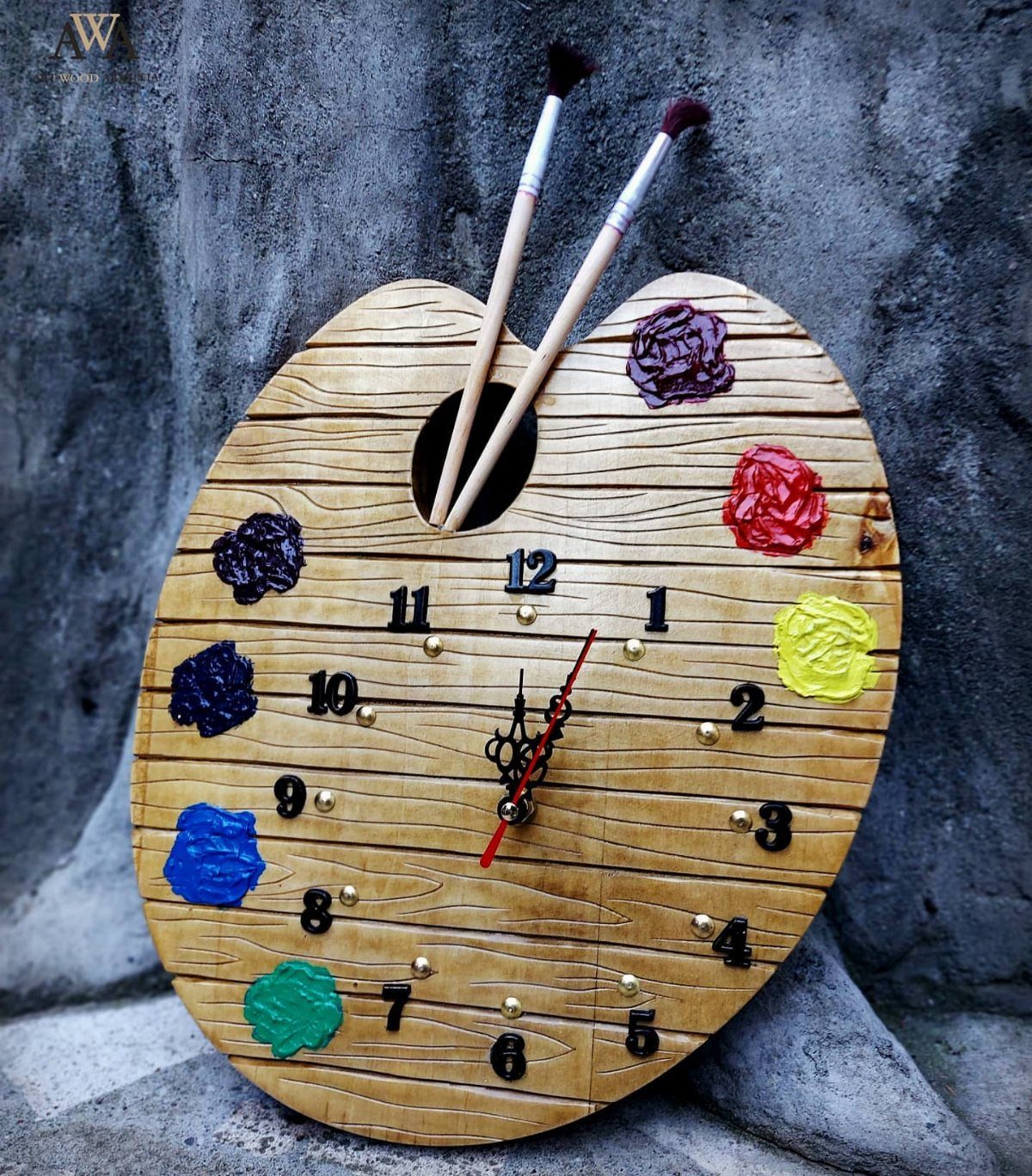 17 Wood Pallet Projects for Furniture, Decor, and Garden 3 Artist palette shaped wooden wall clock with paint splotches and brushes on stone wall