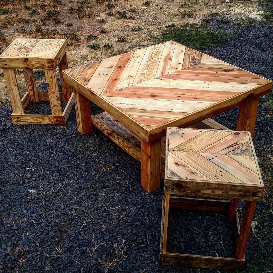 17 Wood Pallet Projects for Furniture, Decor, and Garden 1 Chevron pattern pallet coffee table with two matching wooden stools on dark gravel.