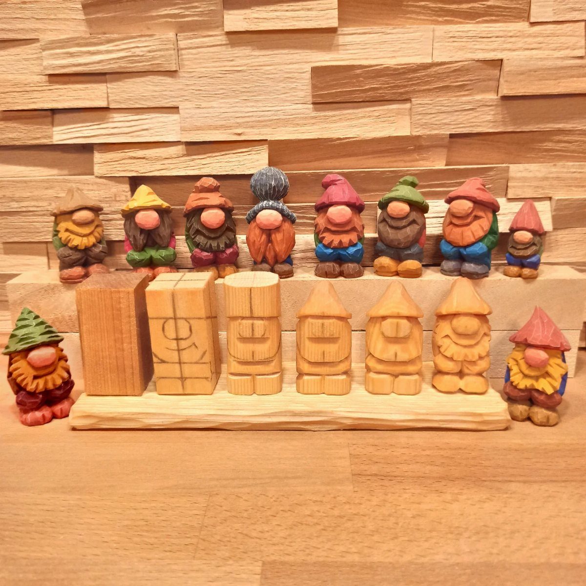 Wood Piece Art Ideas: 25 Designs for Walls and Shelves 24 Carved wooden gnome figurines with colorful hats displayed on wooden shelves.