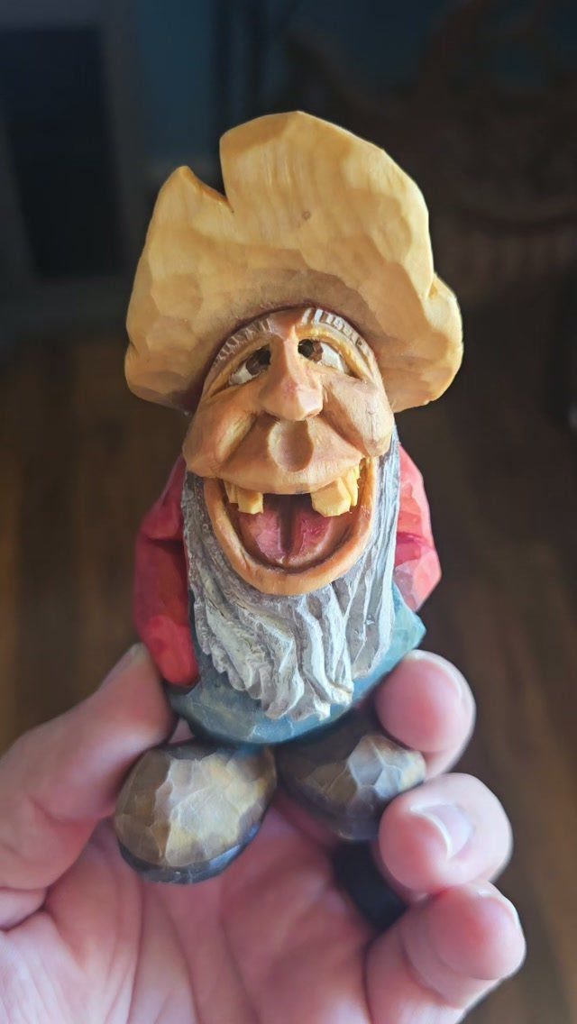 Wood Piece Art Ideas: 25 Designs for Walls and Shelves 20 Hand-carved wooden figurine of a whimsical character with a large hat and white beard.