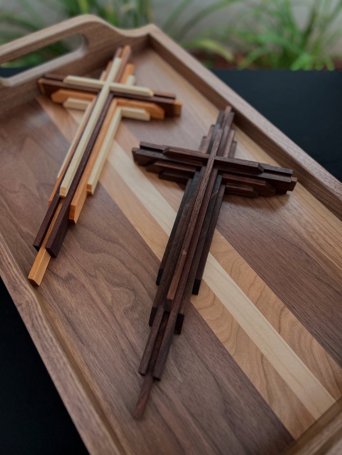 Wood Piece Art Ideas: 25 Designs for Walls and Shelves 23 Two layered wooden crosses in varying brown tones resting on a striped wooden tray.