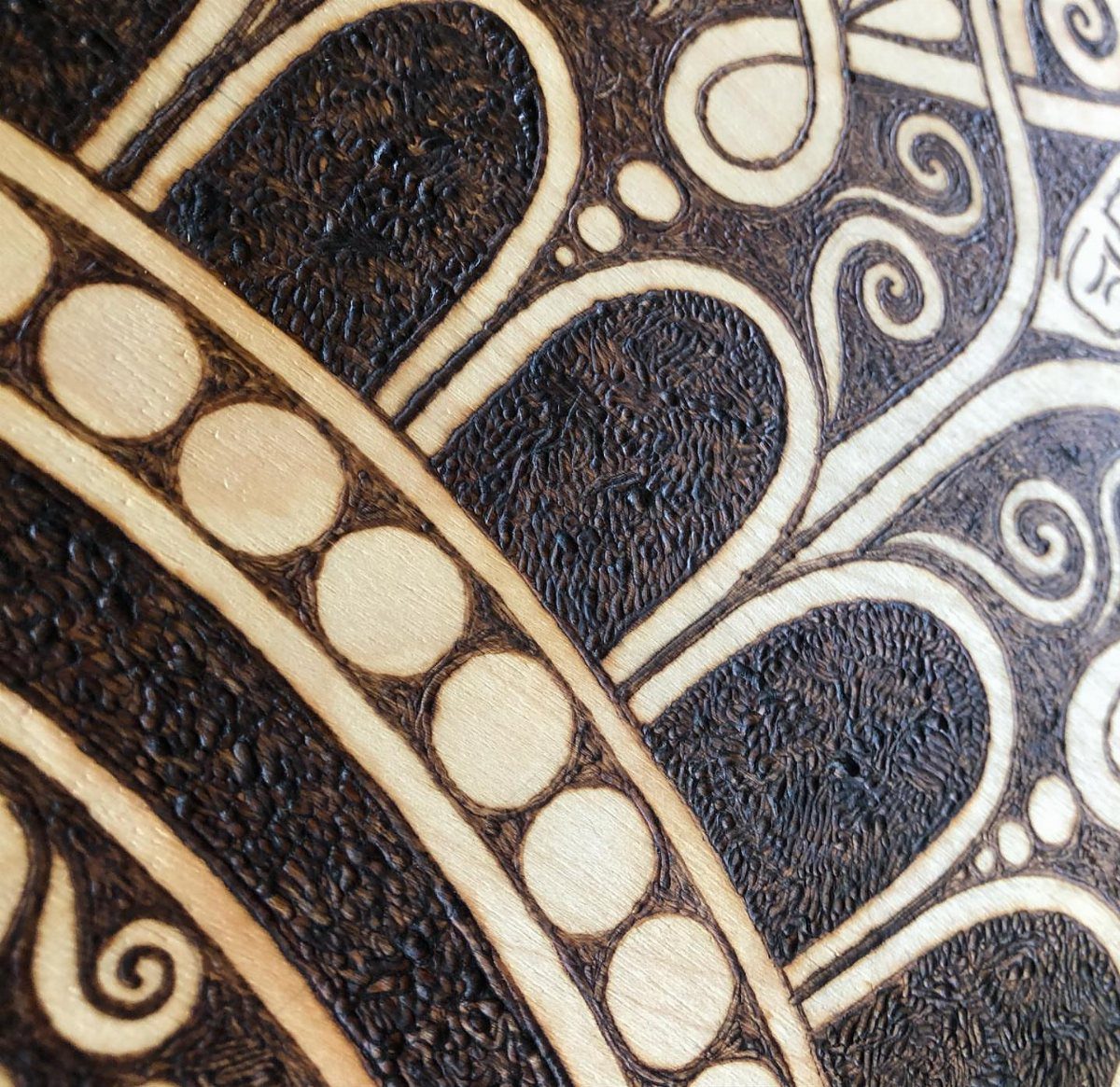 Wood Piece Art Ideas: 25 Designs for Walls and Shelves 11 Intricate wood-burned mandala design with circular patterns and swirls on light wood.