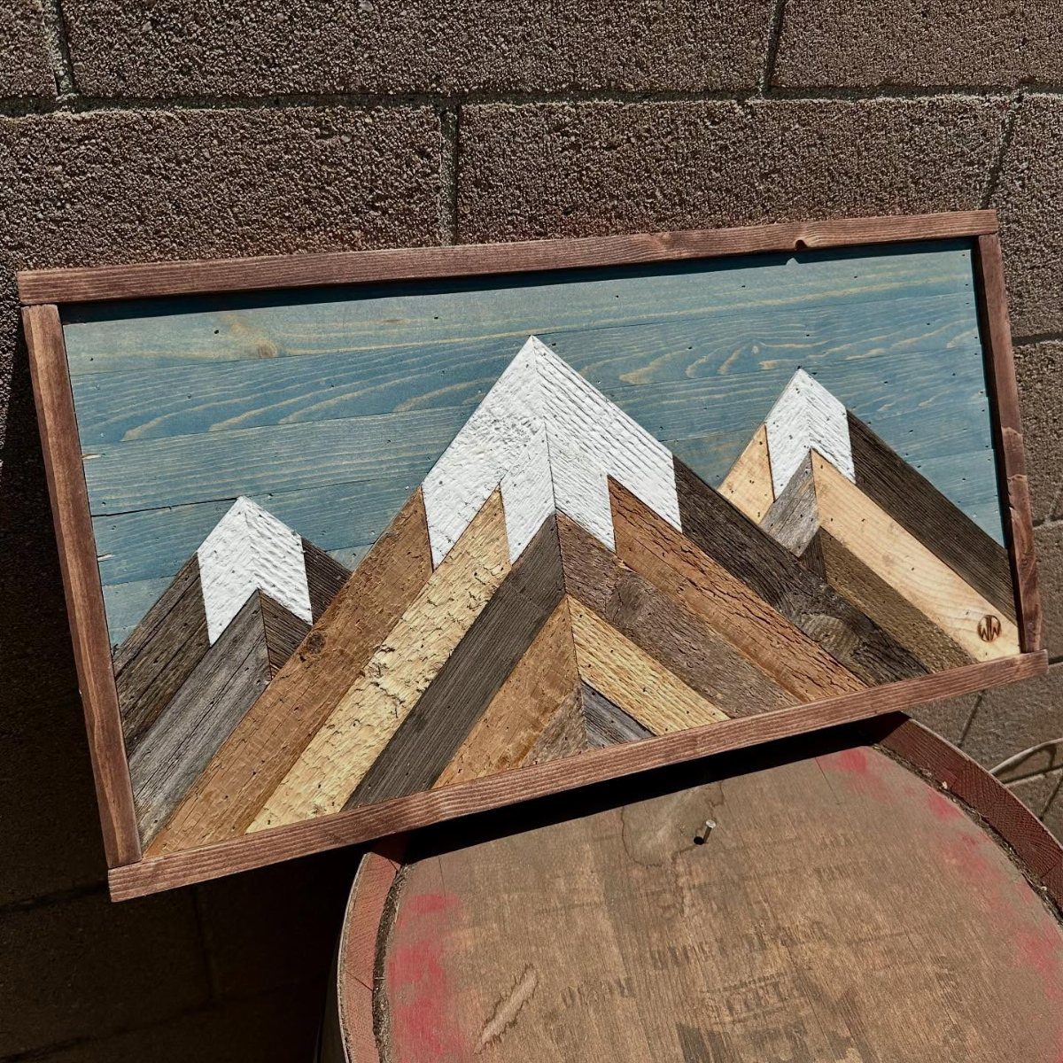 Wood Piece Art Ideas: 25 Designs for Walls and Shelves 1 Three-dimensional wooden mountain wall art with white peaks against a blue sky background.