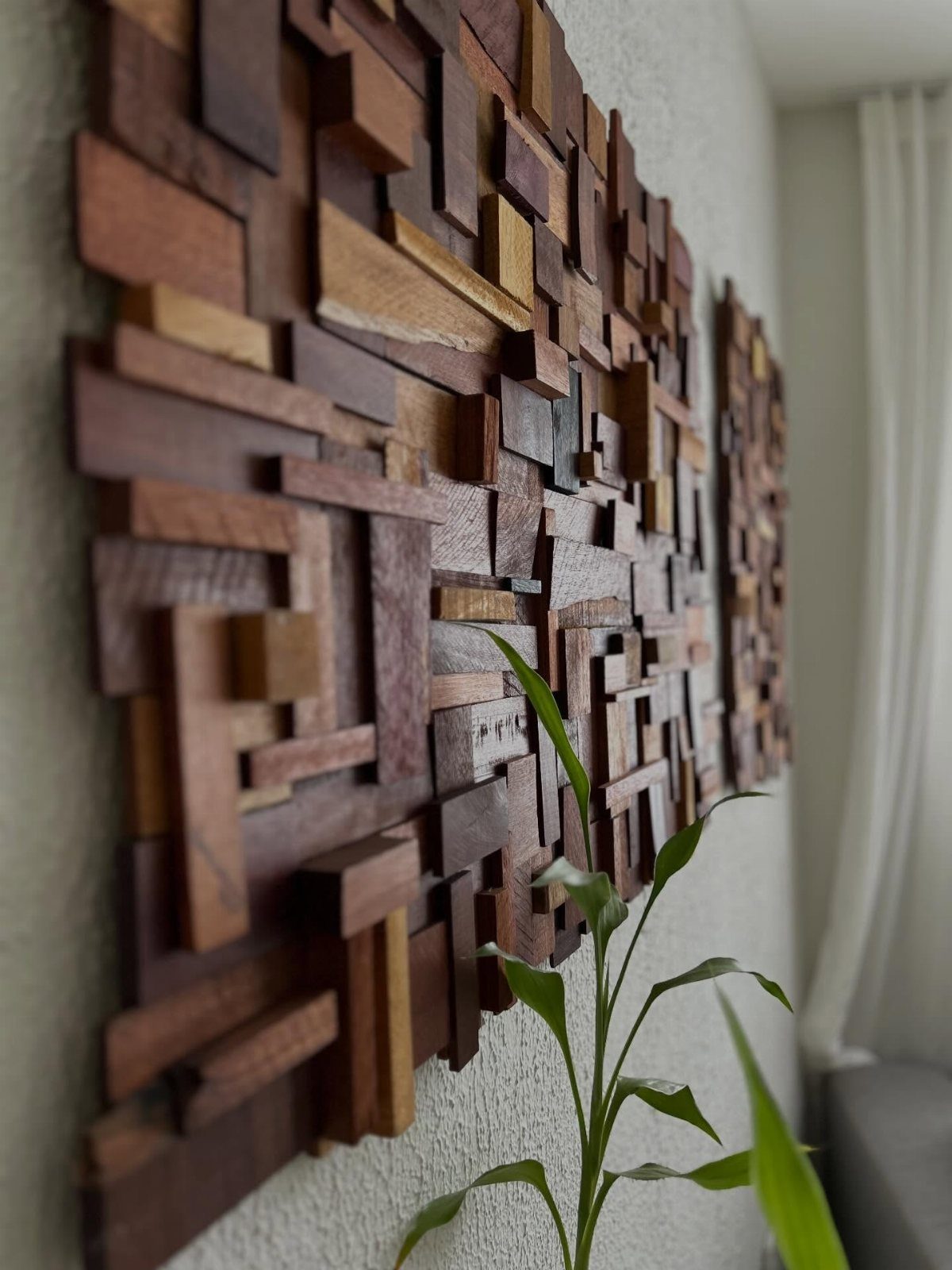 Wood Piece Art Ideas: 25 Designs for Walls and Shelves 9 Wooden wall sculpture featuring interlocking brown rectangular blocks of varying depths on white wall.