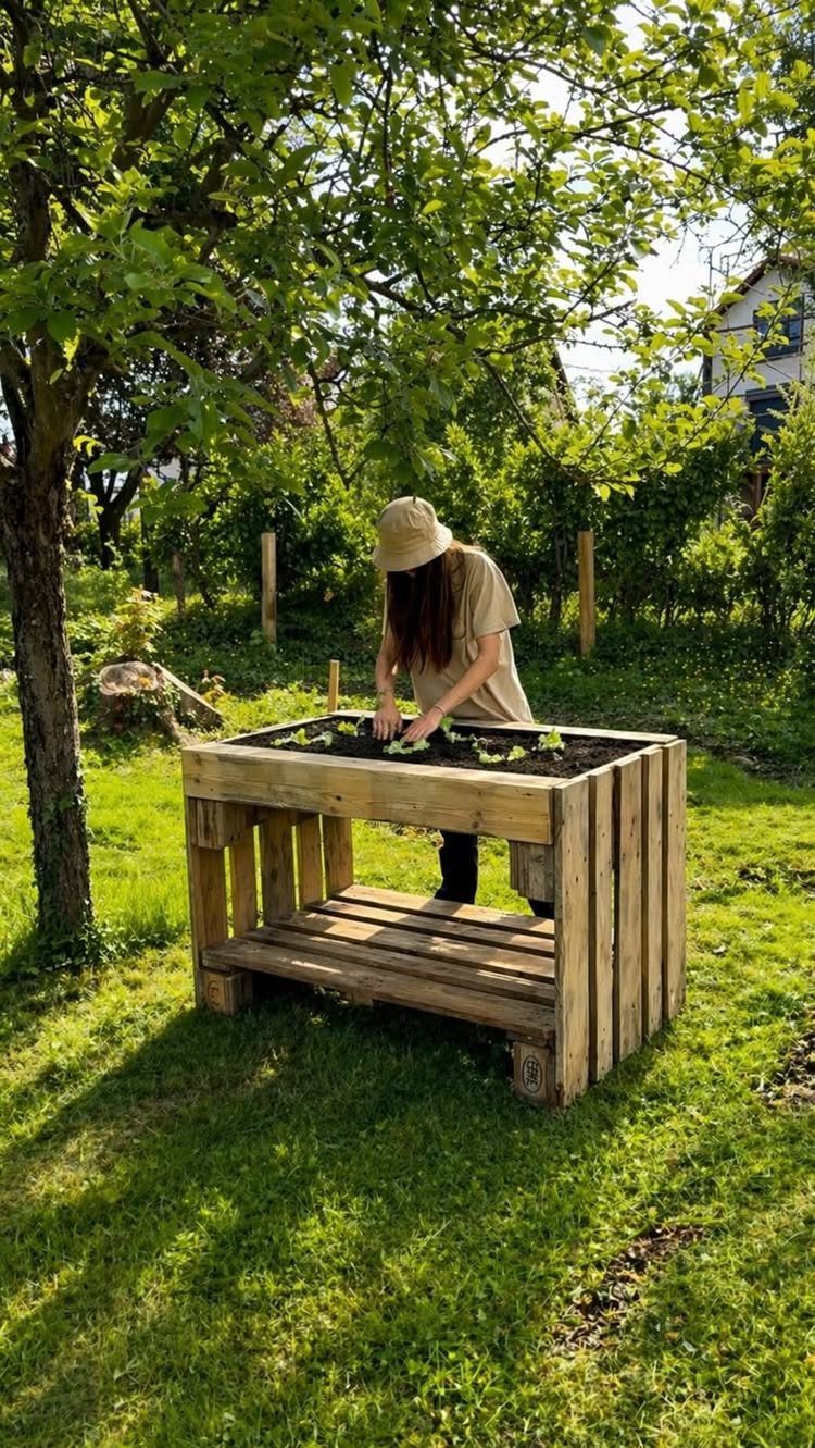 18 Wood Projects with Plans for Every Skill Level 6 Raised wooden planter box with a lower shelf in a sunny garden setting.