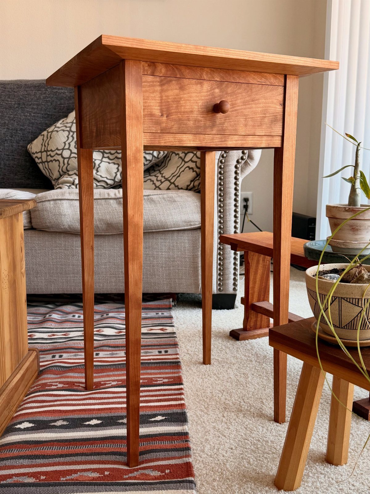 18 Wood Projects with Plans for Every Skill Level 10 Wooden Shaker style side table with a single drawer in a living room setting.