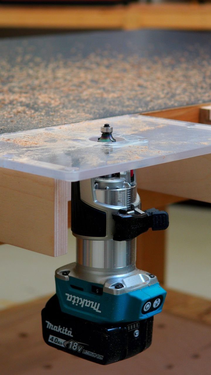 Wood Router Table Ideas: 6 Setups for Your Workshop 6 Makita cordless router mounted under a wooden table with a clear plastic insert.
