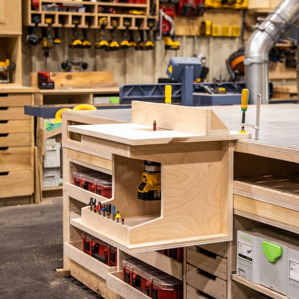 Wood Router Table Ideas: 6 Setups for Your Workshop 3 Plywood router table integrated into a large workshop workbench with tool storage.