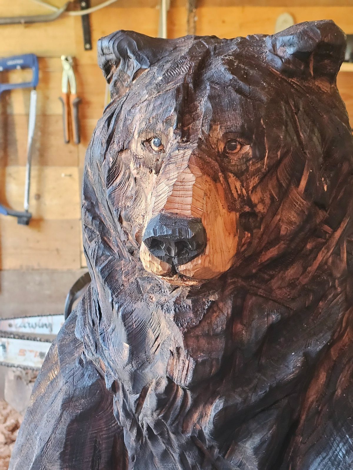 Wood Statue Carving: 6 Ideas from Mushrooms to Bears 2 Wooden bear statue carving with dark brown finish in a workshop setting