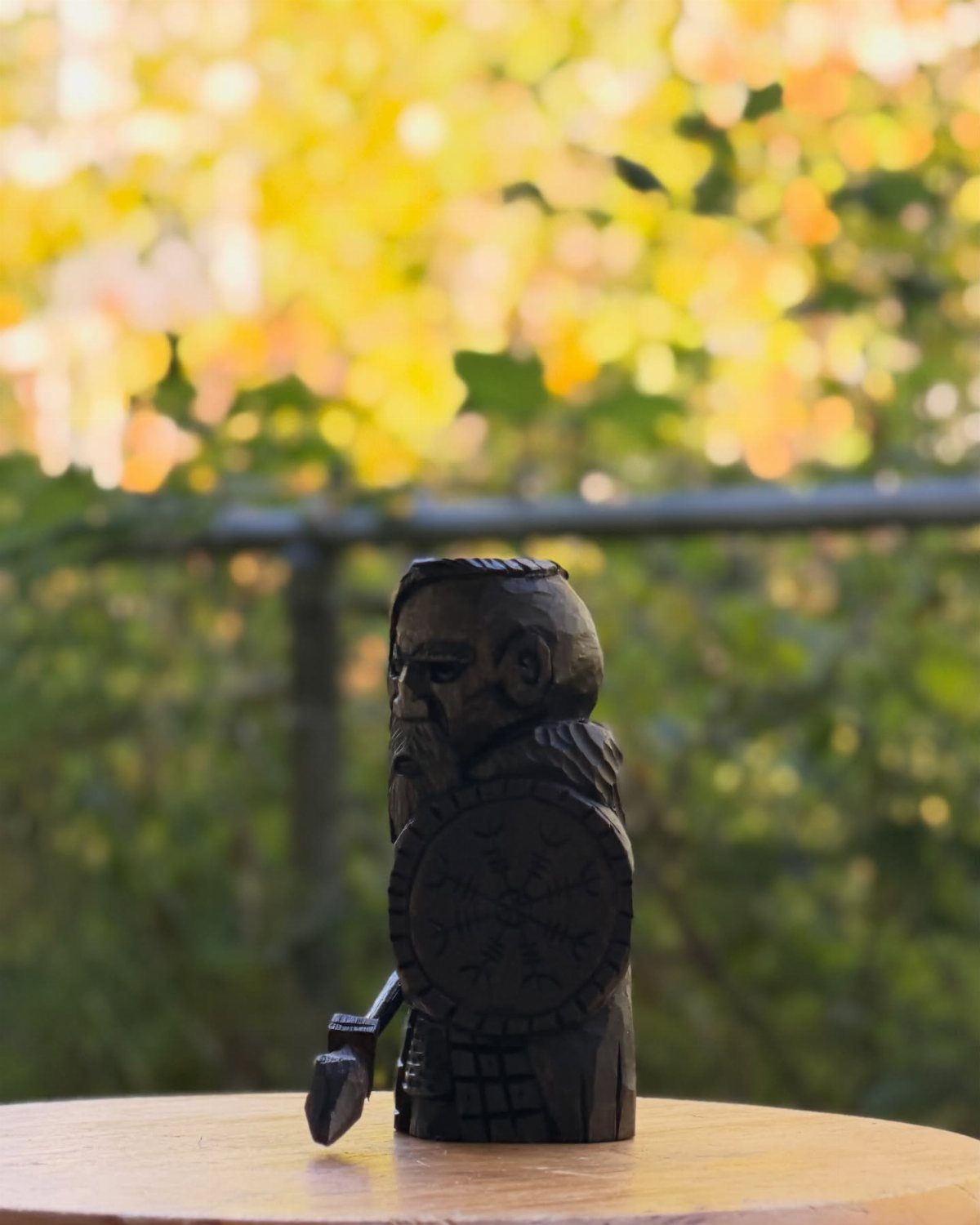 Wood Statue Carving: 6 Ideas from Mushrooms to Bears 5 Carved wooden warrior statue with shield and axe on a wooden table.