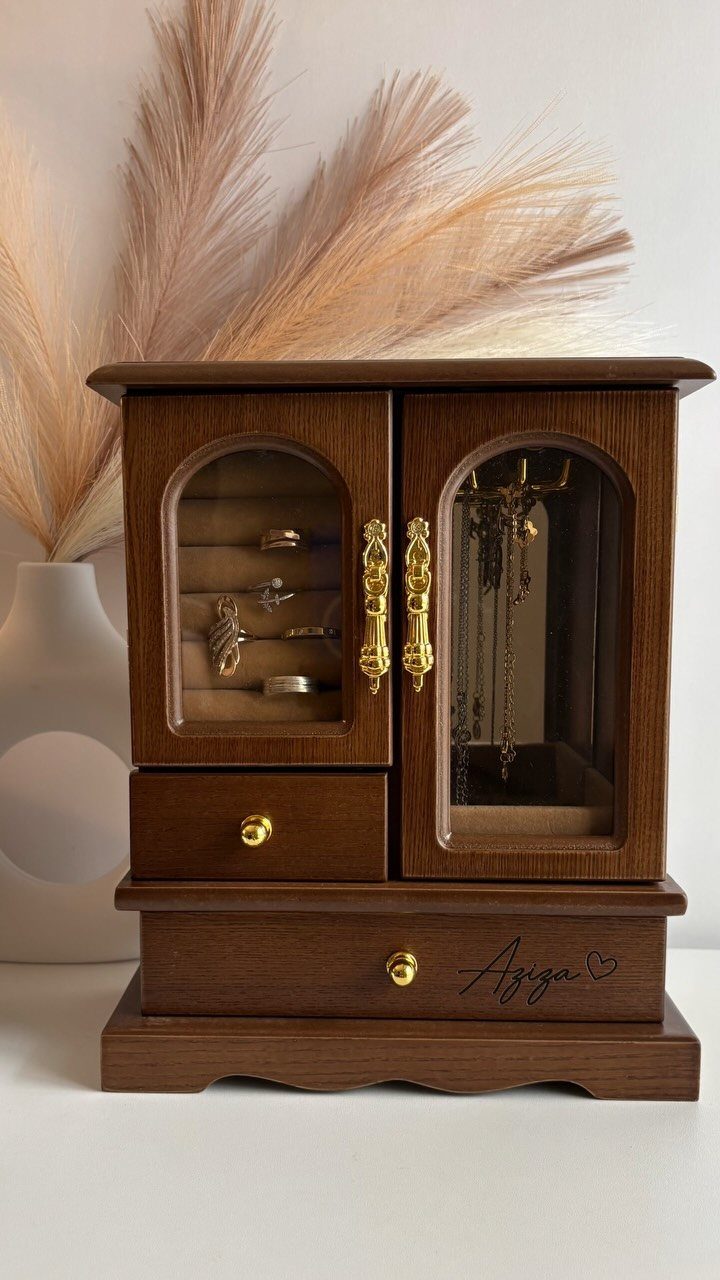 7 Wooden Box Designs for Jewelry, Tissue and Storage 3 Wooden jewelry box with glass doors and gold hardware holding rings and necklaces.