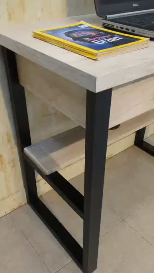 Light wooden desk with black metal legs and a lower storage shelf.