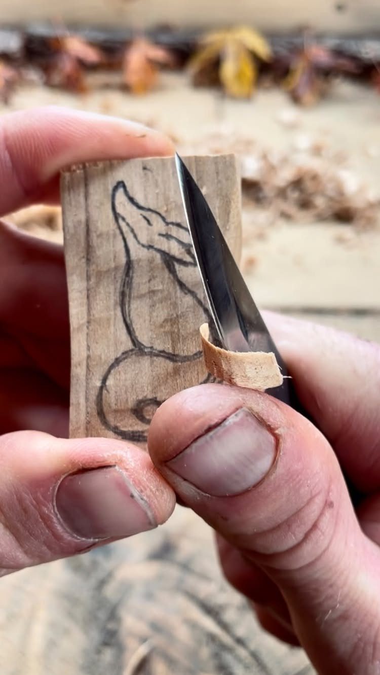 7 Ideas for Wooden Duck Carving, From Decoys to Flight Poses 3 Hands carving a wooden duck outline from a block using a sharp knife.