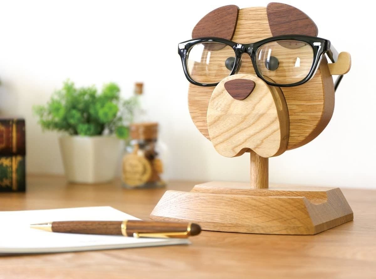 Wooden Glasses Holder: 10 Ideas for Every Desk 1 Wooden dog head eyeglass stand wearing black glasses on a wooden desk.