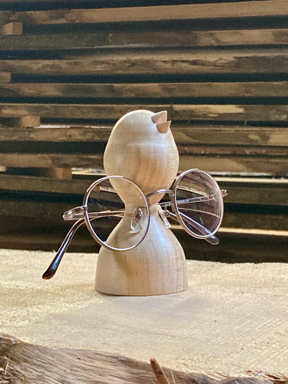 Wooden Glasses Holder: 10 Ideas for Every Desk 10 Wooden bird shaped holder supporting a pair of round eyeglasses on a light surface