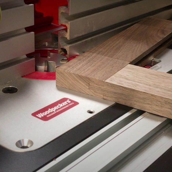 Woodpeckers Router Table Setups: 5 Ideas for Your Shop 3 Woodpeckers router table with a wooden piece being routed on a metal surface.