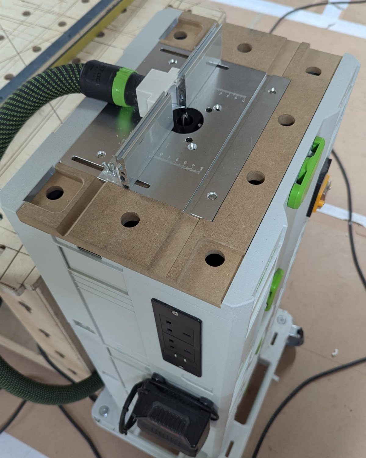 Woodpeckers Router Table Setups: 5 Ideas for Your Shop 4 Woodpeckers router table with a silver fence and green dust collection hose.