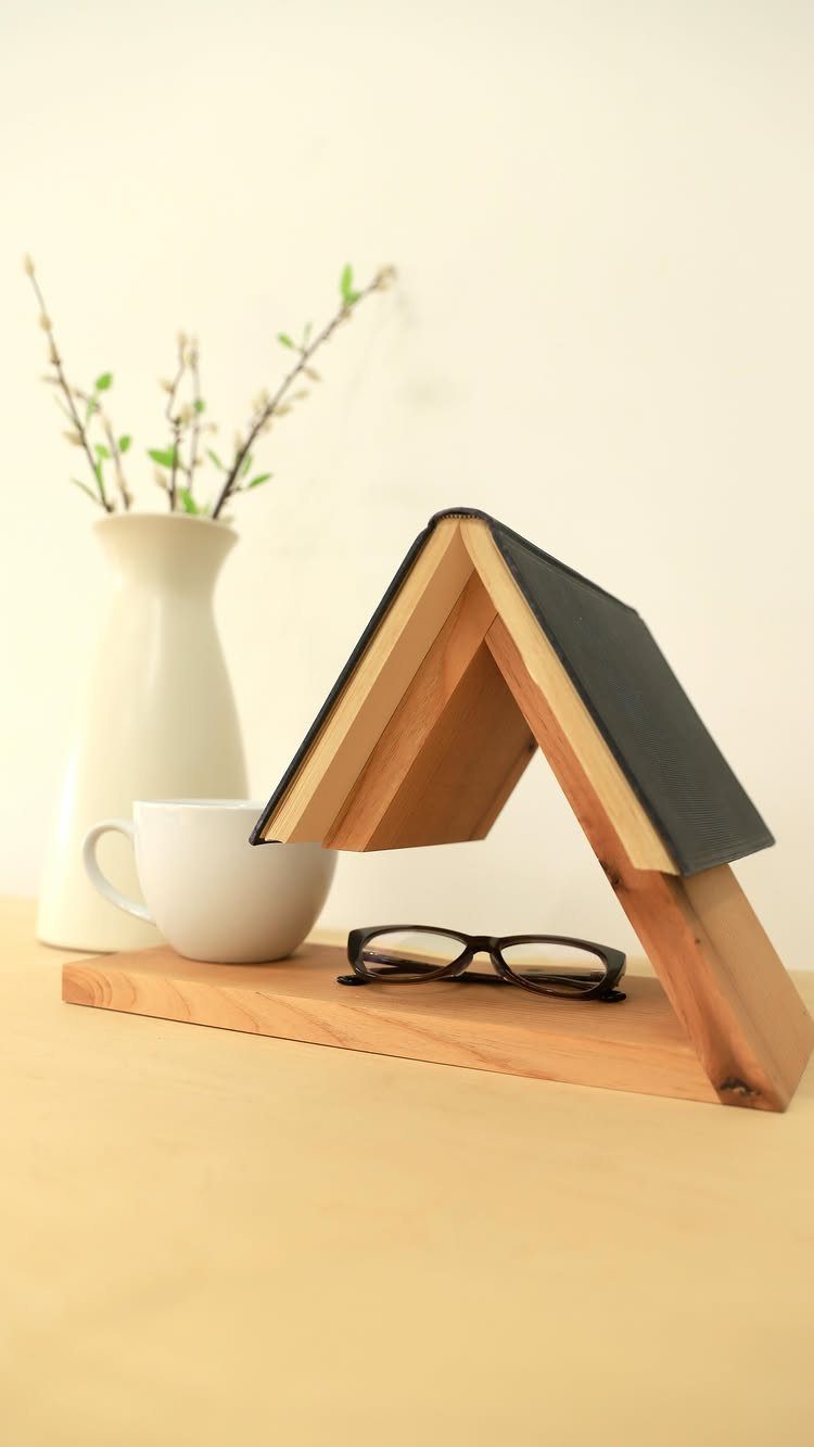 Woodworking Book Holder Ideas: 4 Designs to Build 1 Wooden triangular book holder supporting an open book next to a coffee cup.