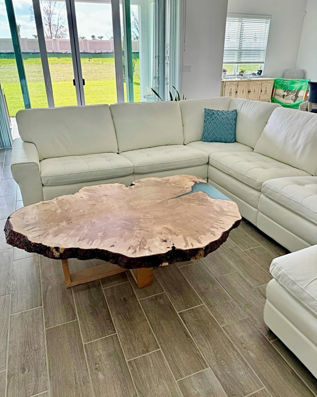 9 Woodworking Coffee Table Ideas for Every Skill Level 2 Live edge wood slab coffee table in a modern living room with white sofa.