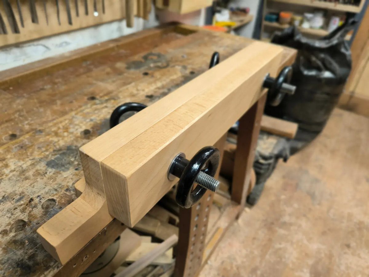 5 Woodworking End Vise Ideas for Your Workbench 5 Wooden end vise with black hand-screws mounted on a rustic woodworking workbench